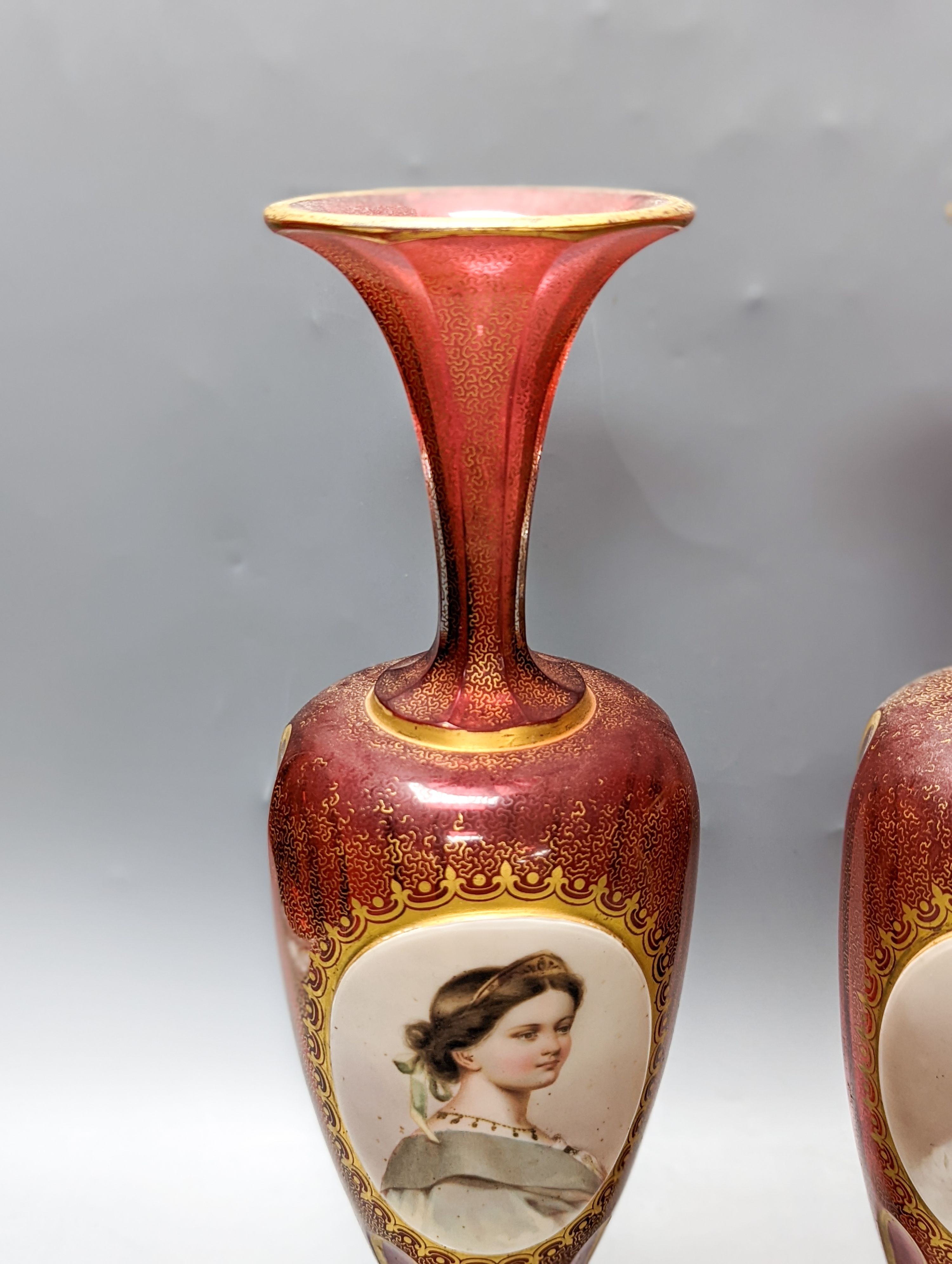 A pair of Bohemian enamelled and overlaid cranberry glass vases, 19th century 35cm